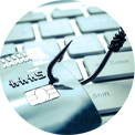 Credit card with a fishing hook on a computer keyboard, symbolizing phishing and cybercrime.