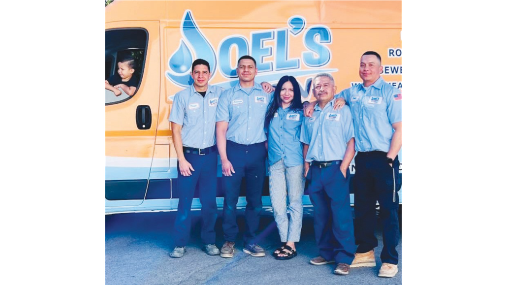 A group of people standing in front of a yellow van that says soel 's