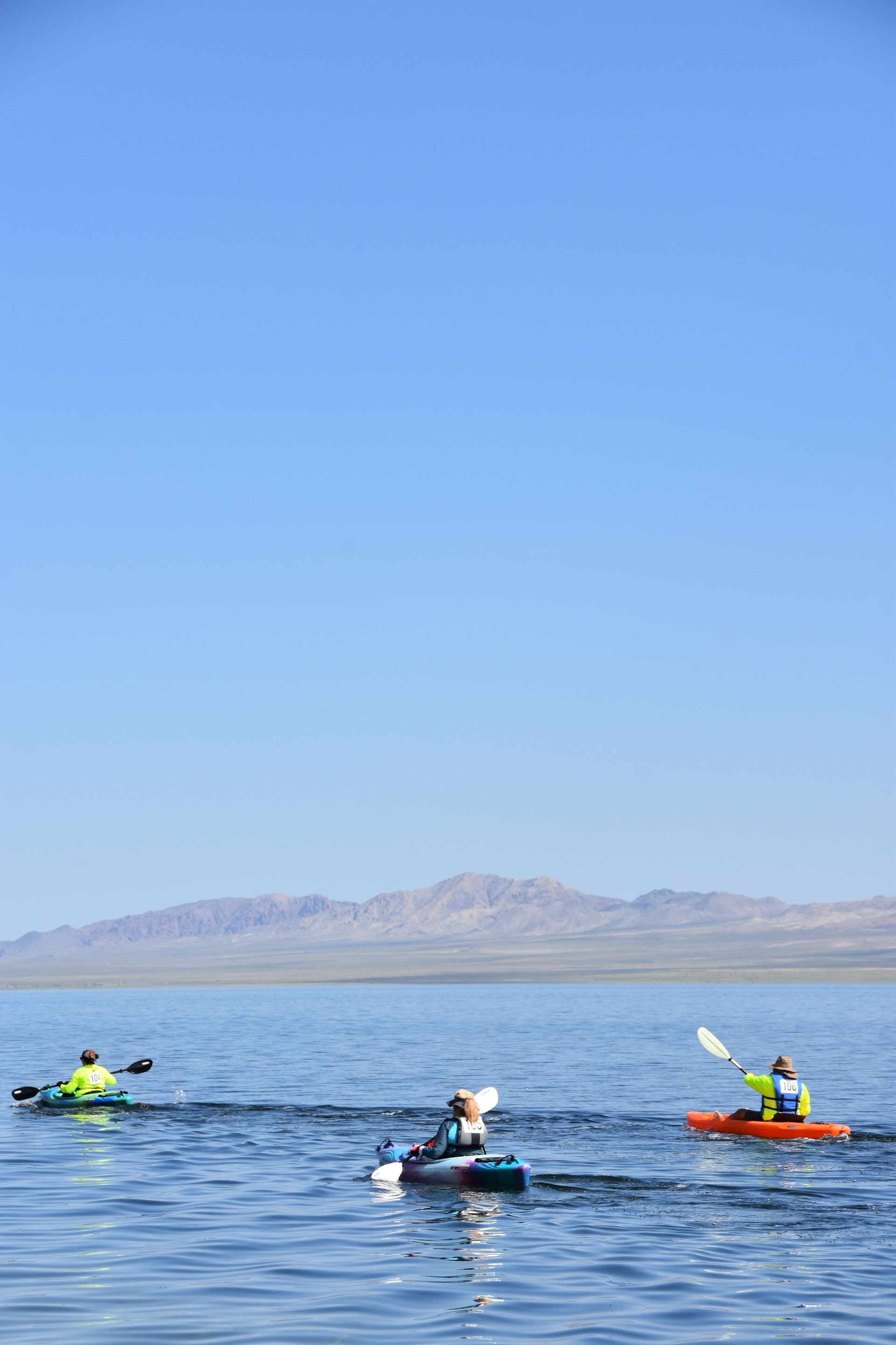 A group of people are kayaking on a lake.