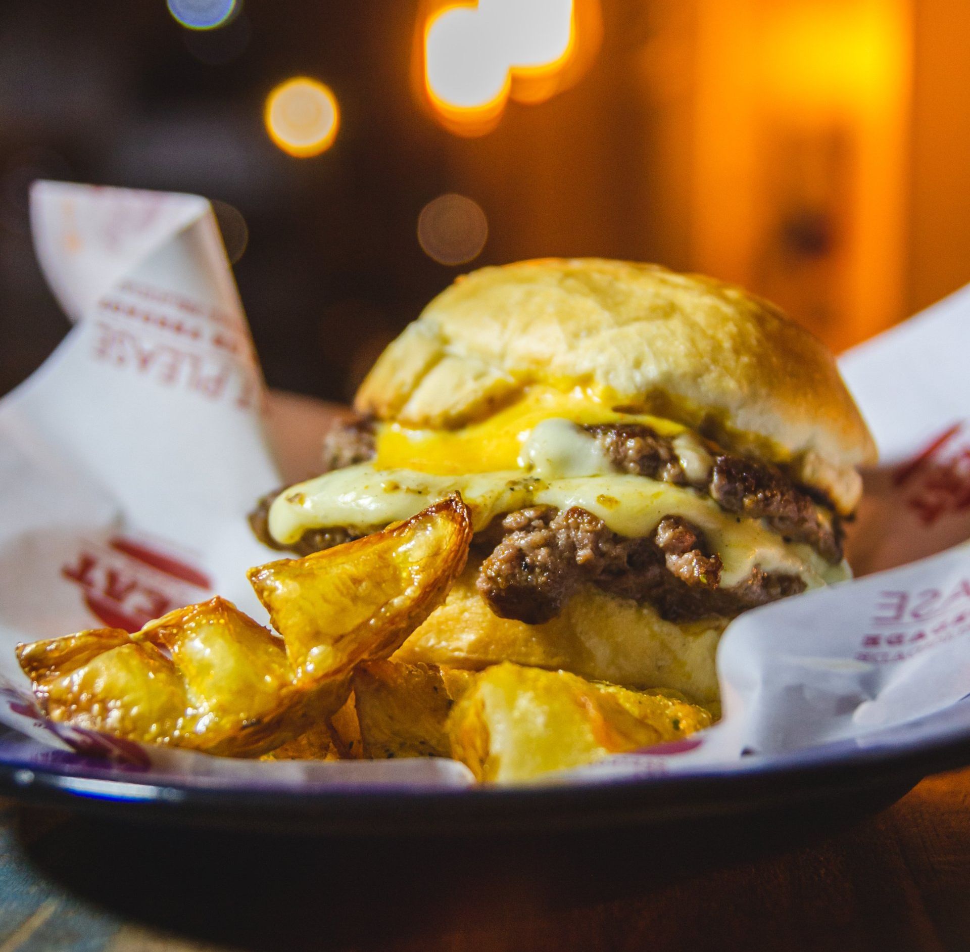 A close up of a hamburger and french fries on a plate