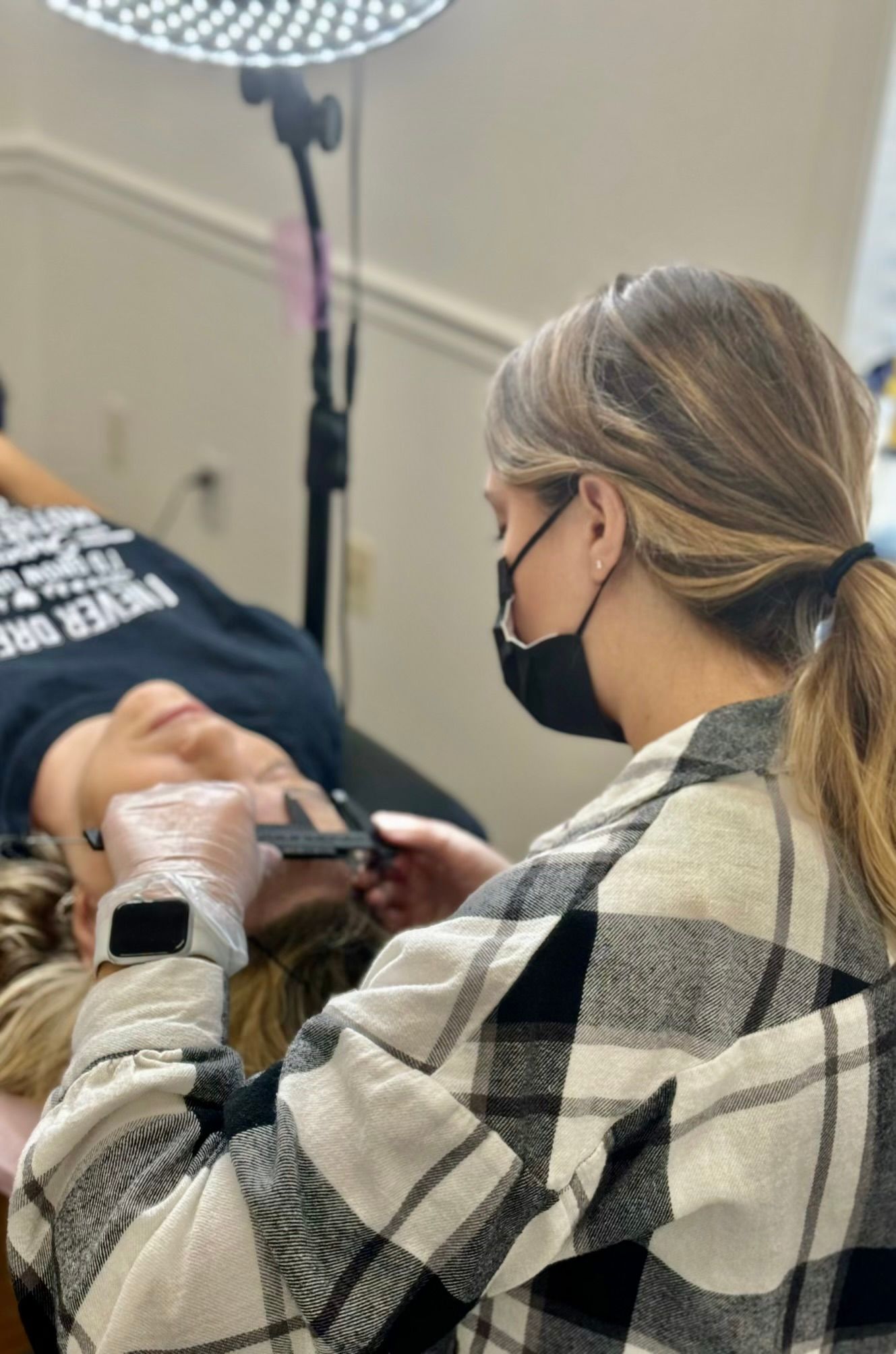 Microblading artist practicing different shading techniques on paper.