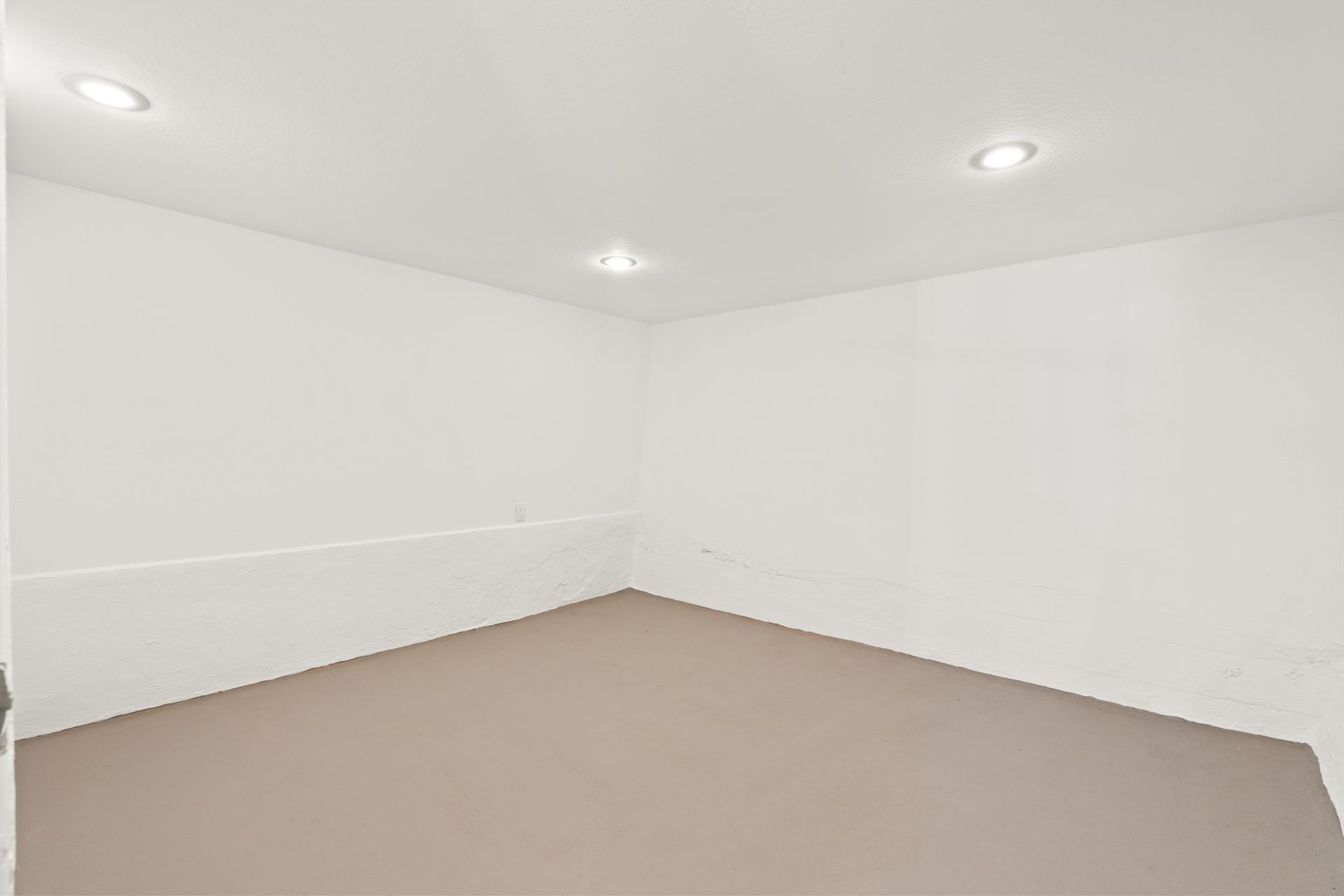 An empty room with white walls.