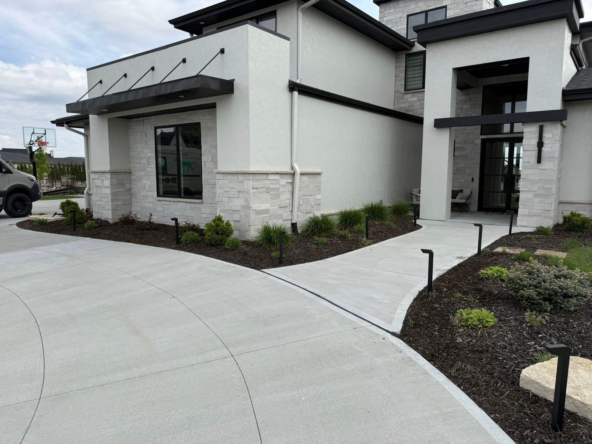 Omaha house during the day with exterior lights from Earl Outdoor Solutions.