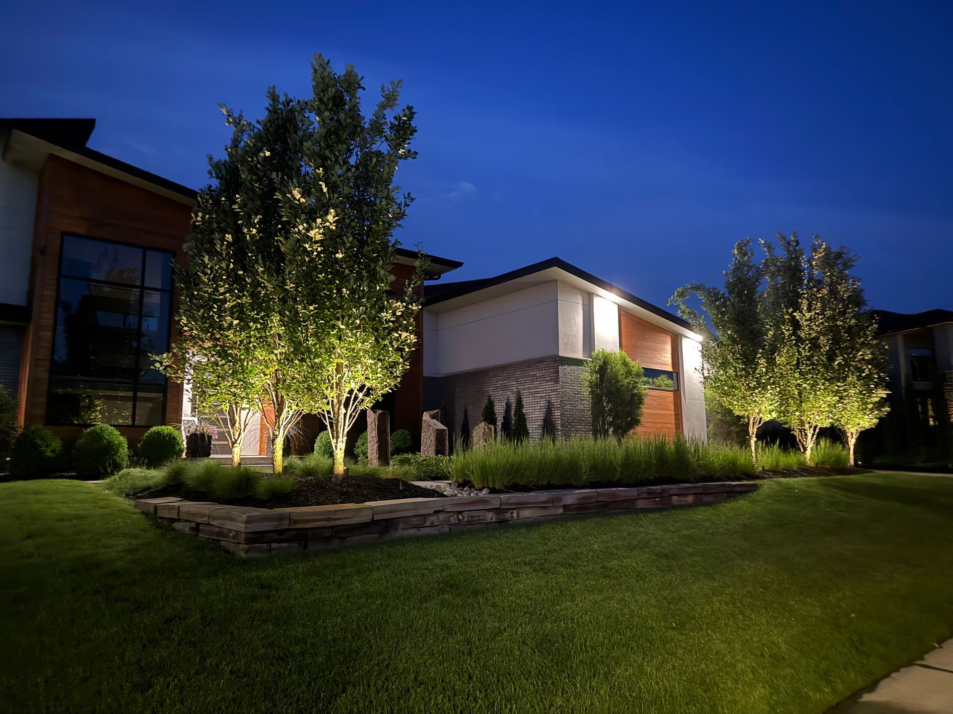 Professional landscape lighting installation in Omaha backyard by Earl Outdoor Solutions