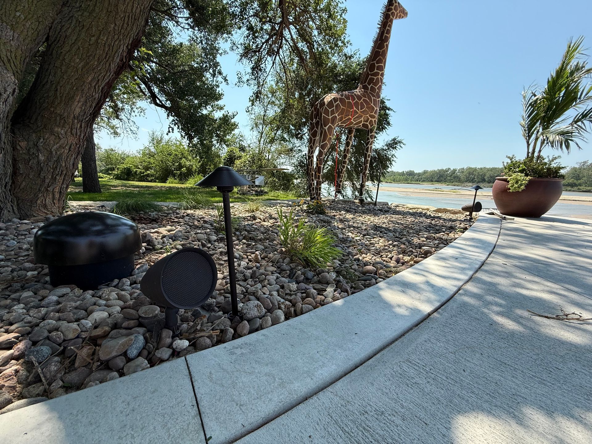 Professional landscape lighting installation on stone path and water feature — Omaha