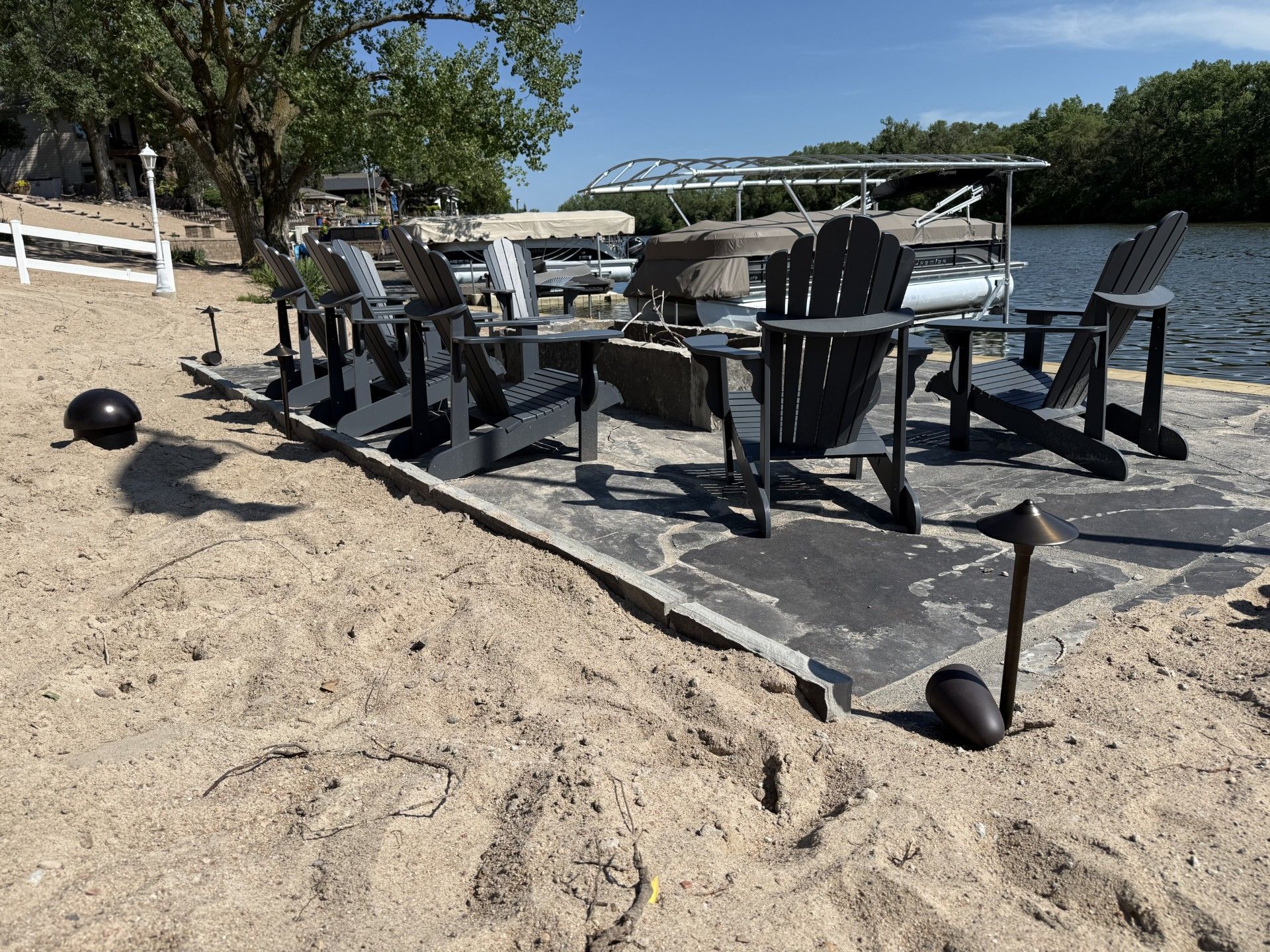 Outdoor landscape lighting at waterfront property with fire pit — Earl Outdoor Solutions