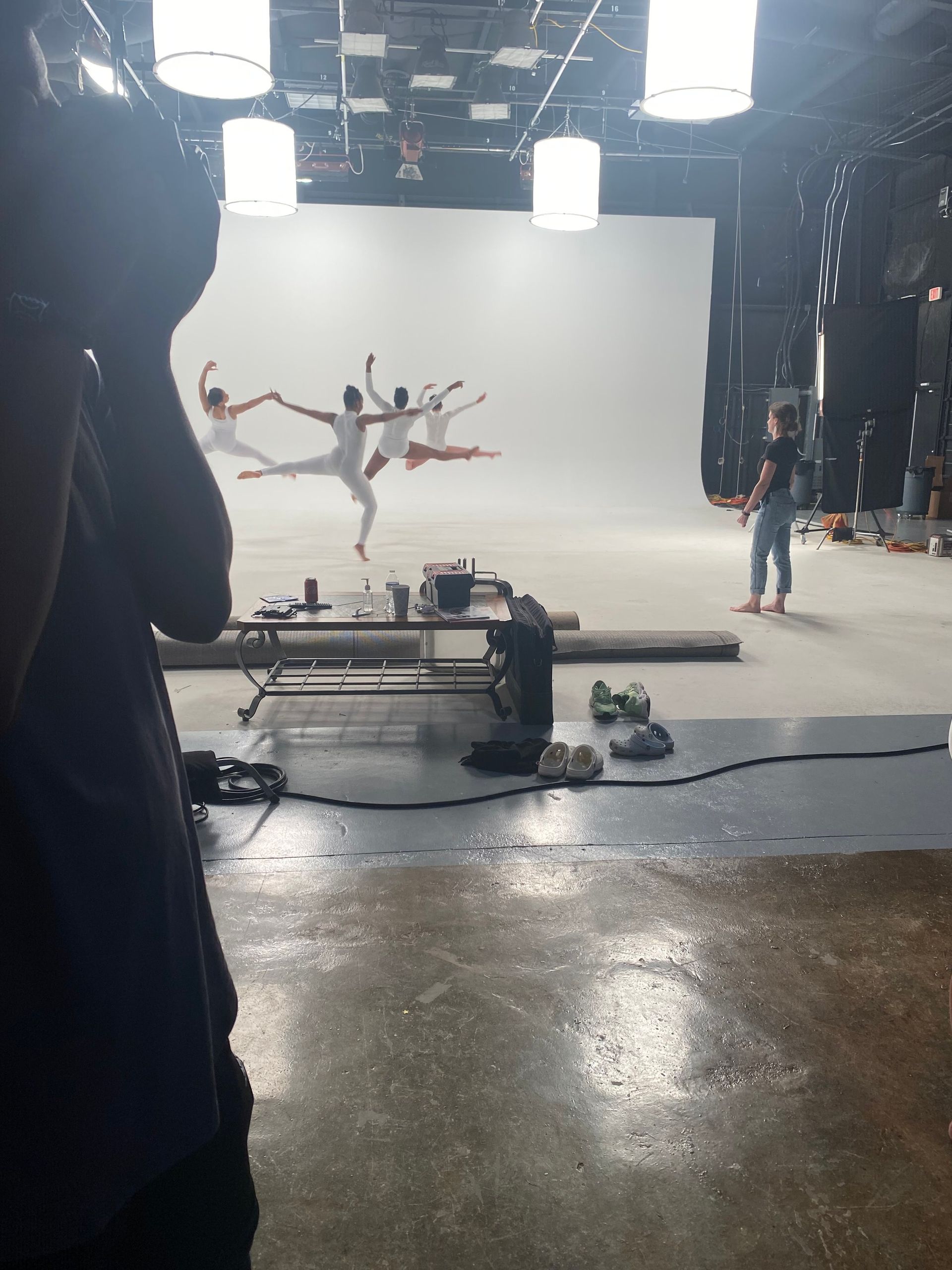 A man is taking a picture of a group of dancers in a studio