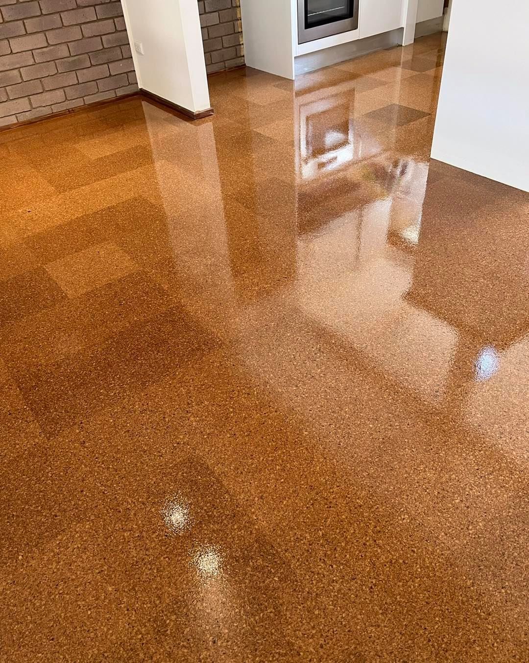 Brown Speckled Flooring Reflecting Light in A Room with White Walls — Canberra Floor Coverings in Queanbeyan West, NSW