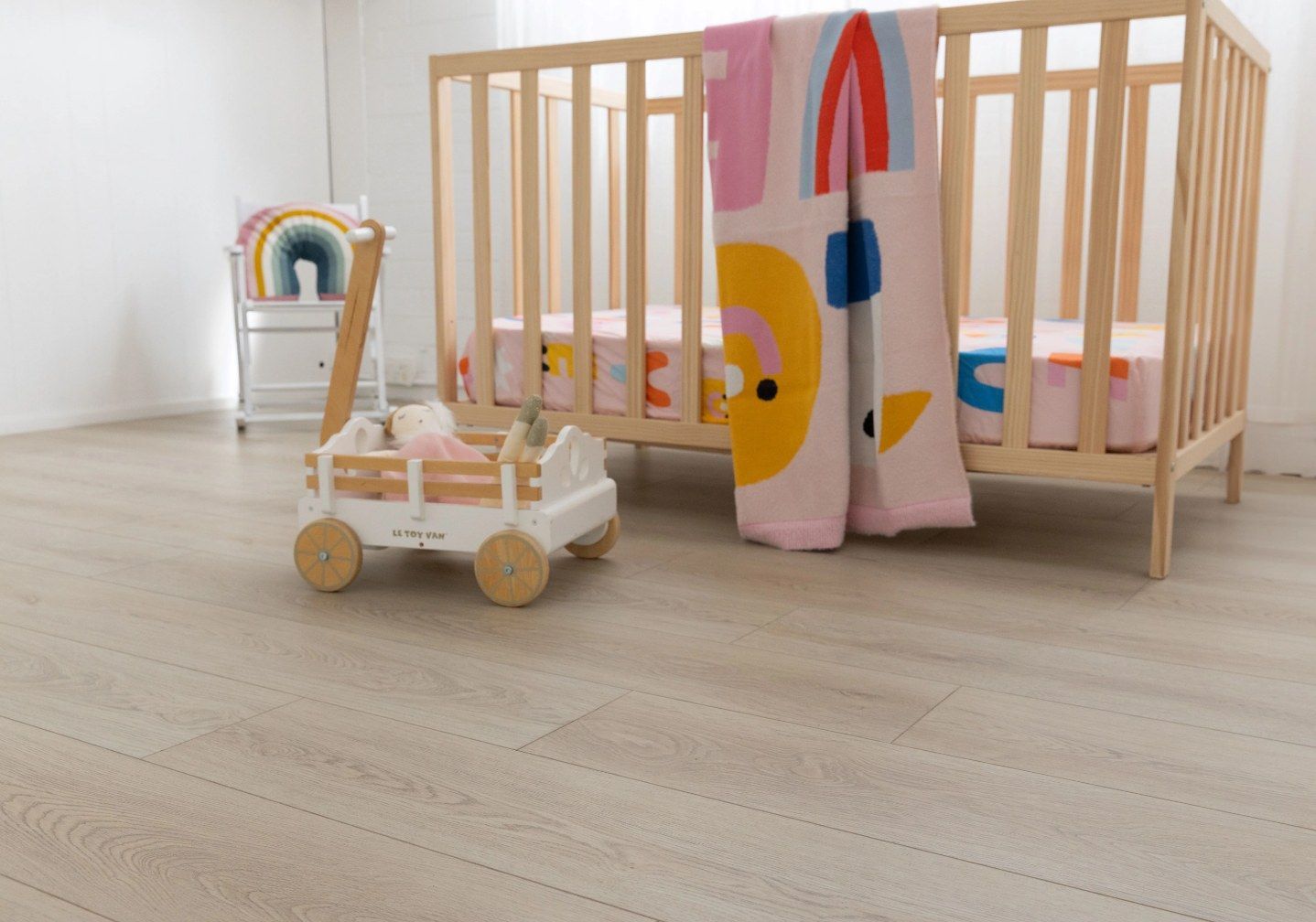 A Wooden Crib and a Floor With a Colourful Blanket — Canberra Floor Coverings in Queanbeyan West, NSW