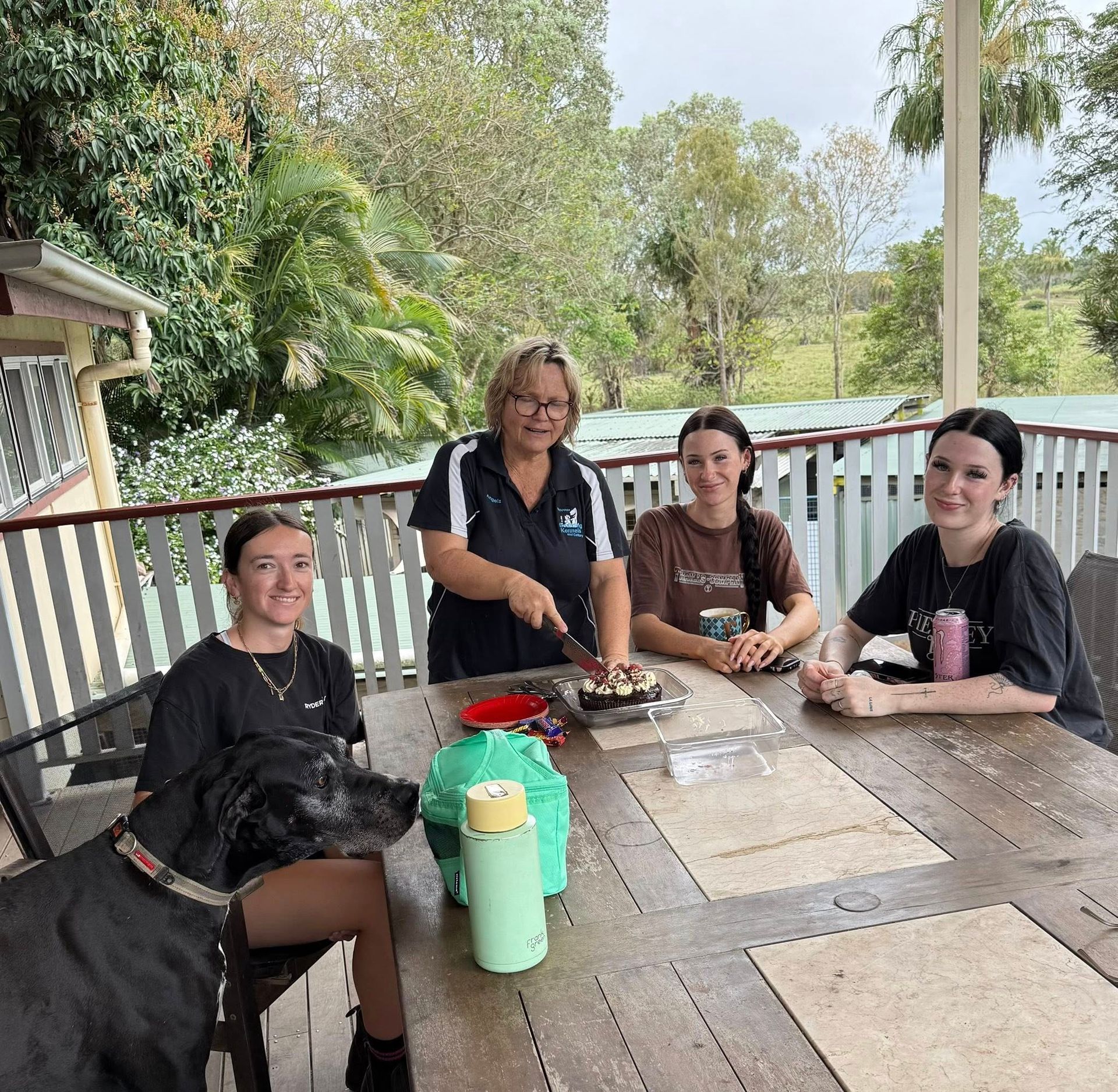 Four People and a Black Dog — Yeppoon Boarding Kennels & Cattery In Farnborough, QLD
