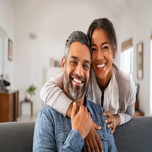 couple hugging and looking at camera
