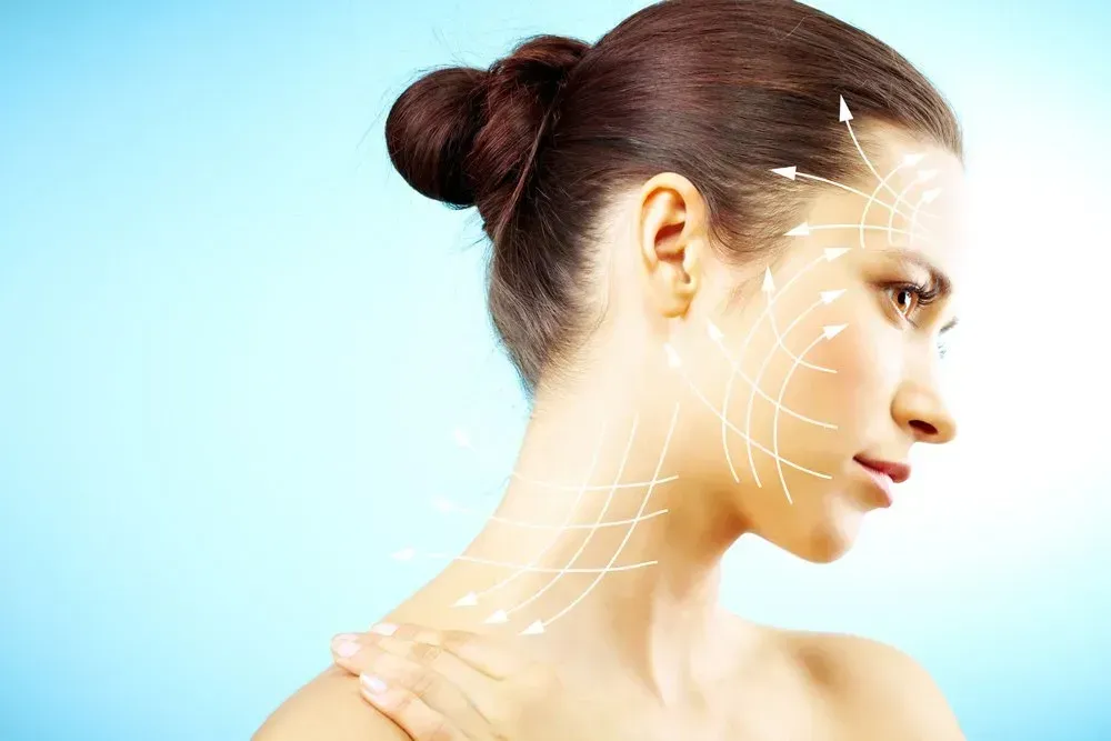 Woman with arrows overlaid on her face and neck, indicating cosmetic enhancements, blue background.