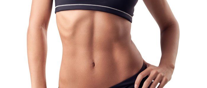 Woman's torso in black sports bra and underwear, hand on hip. Body toned with visible abs.