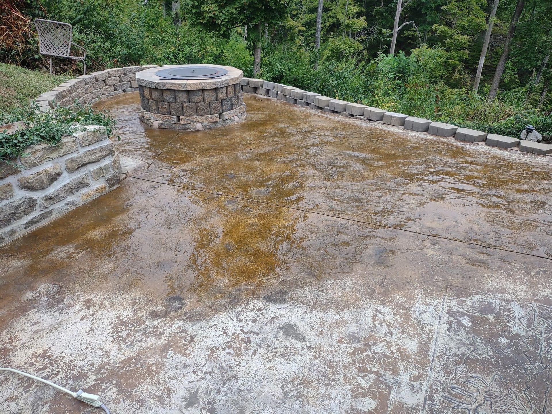 There is a fire pit in the middle of the patio.