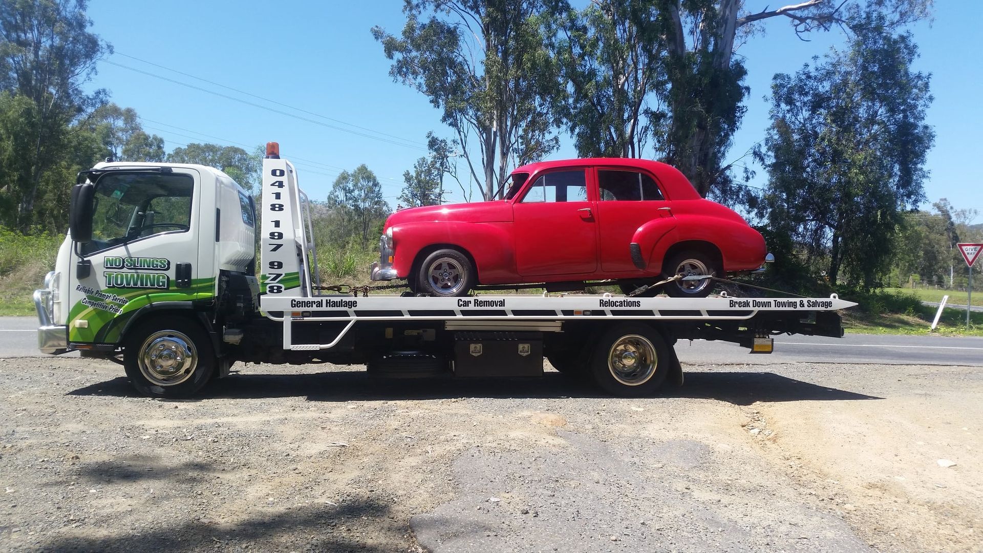 Red Vintage Car on a White Tow Truck. Truck is on Gravel — No Slings Towing in Glendale, QLD