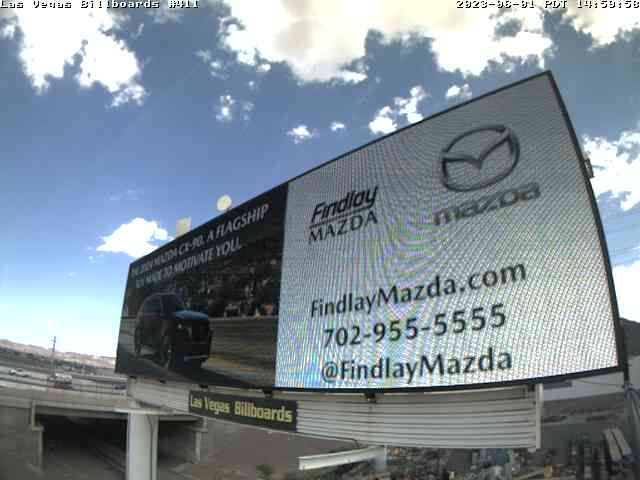 Billboard advertising Findlay Mazda with website and phone number against a blue sky
