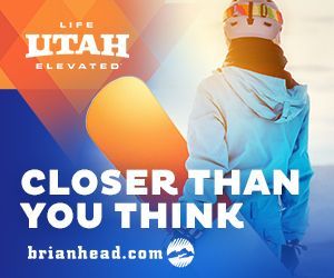 Skier in blue jacket on mountain with slogan “Closer Than You Think” and Brian Head logo
