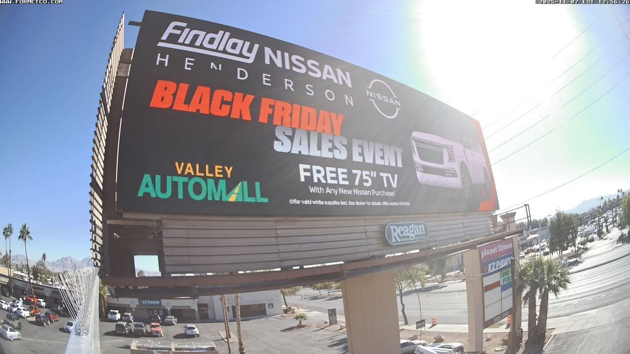 Findlay Nissan billboard advertising Black Friday sales, near Valley Automall on a sunny street.