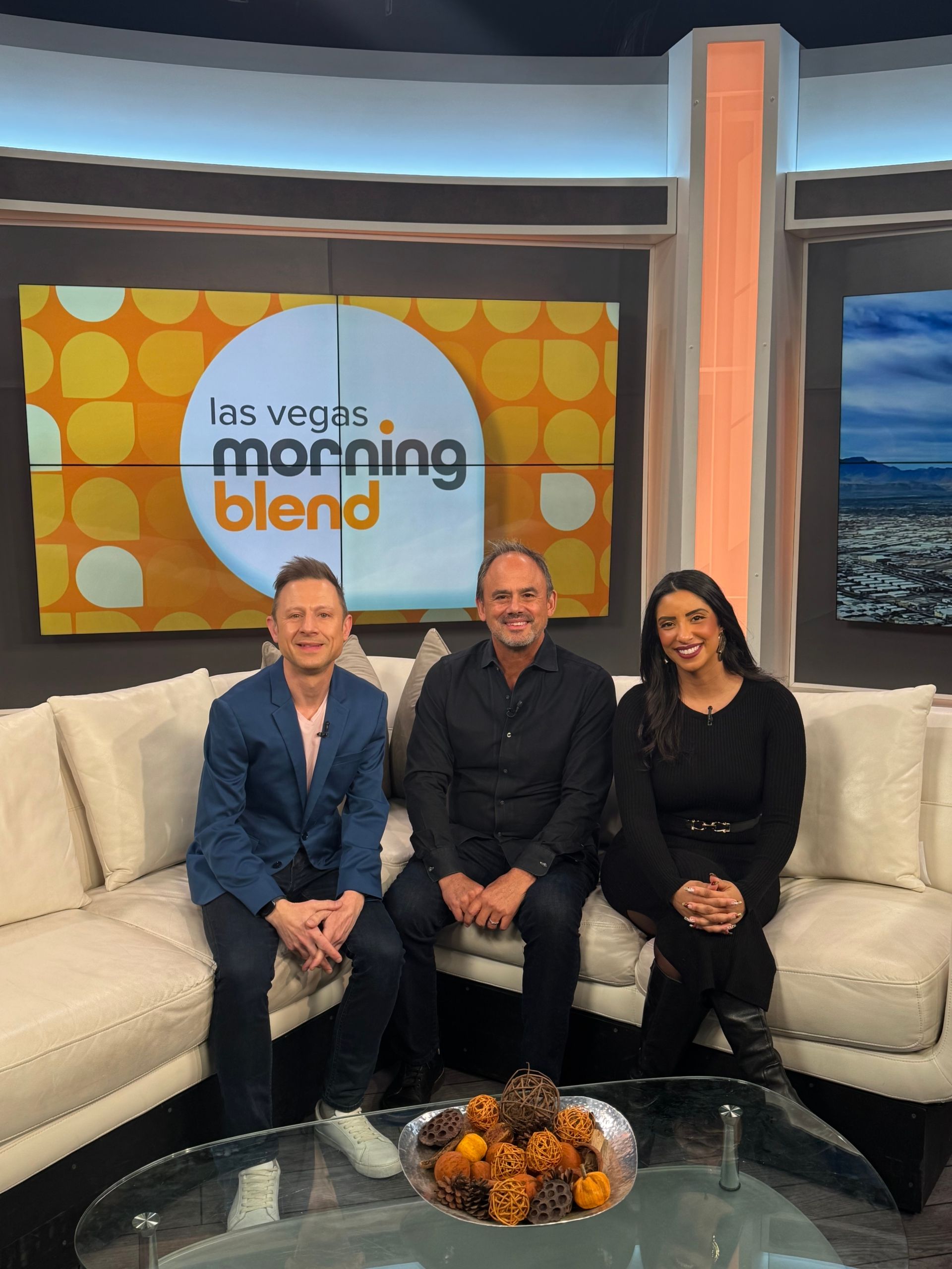Three hosts seated on a studio couch at Las Vegas Morning Blend set