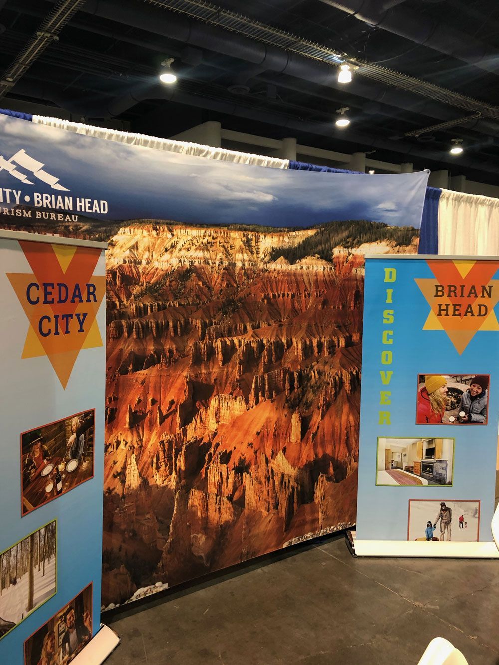 Trade show booth for Cedar City and Brian Head featuring canyon photos and blue display panels