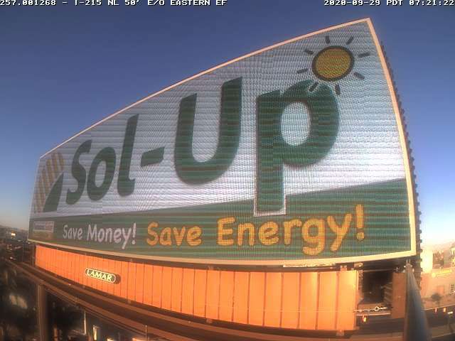 Billboard reading “Sol-Up” and “Save Energy!” with a sun icon at dusk