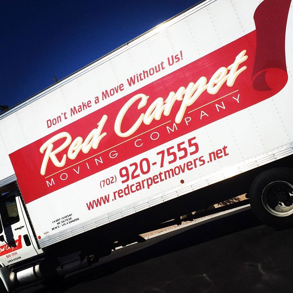 Red Carpet Moving Company truck with red-and-white logo and phone number on the side.