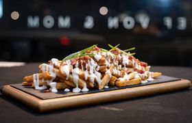 Smothered fries displayed on a cutting board