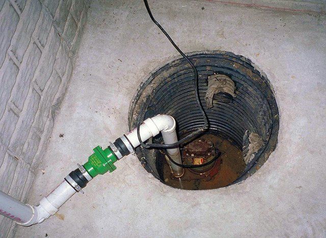 Image of a real Sump pump and Sump pump pit in a home. The picture is for Sump Pump Installation service