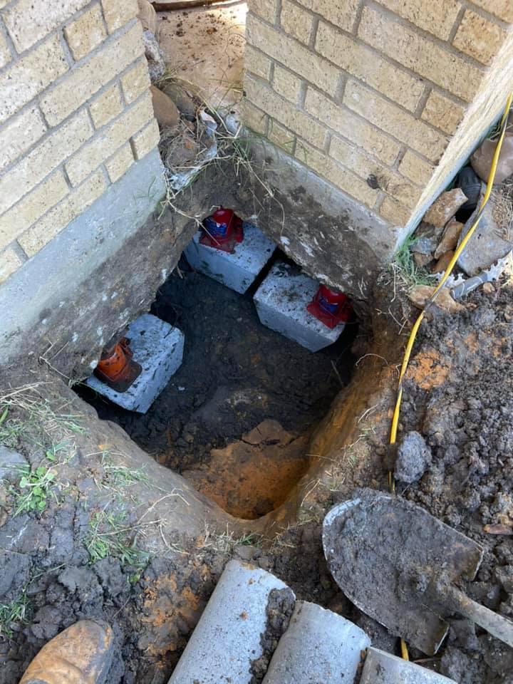 Foundation being lifted by slab jacking and lifting. As you can see the slabs and jacks