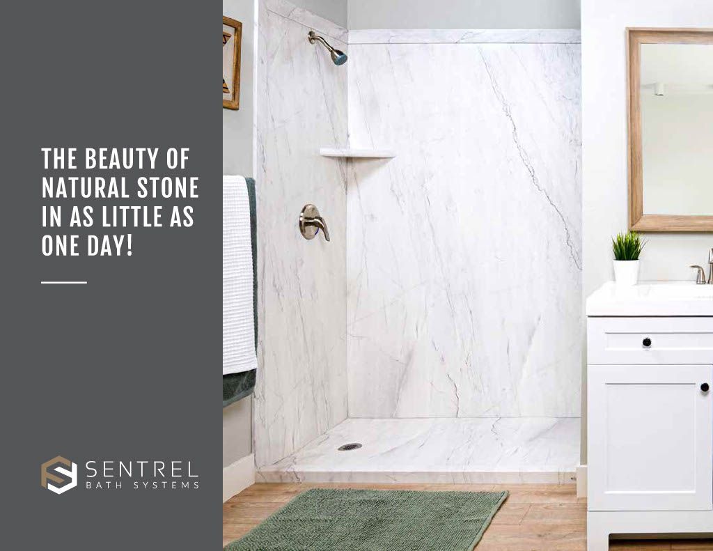 A bathroom with a walk in shower and a sink.