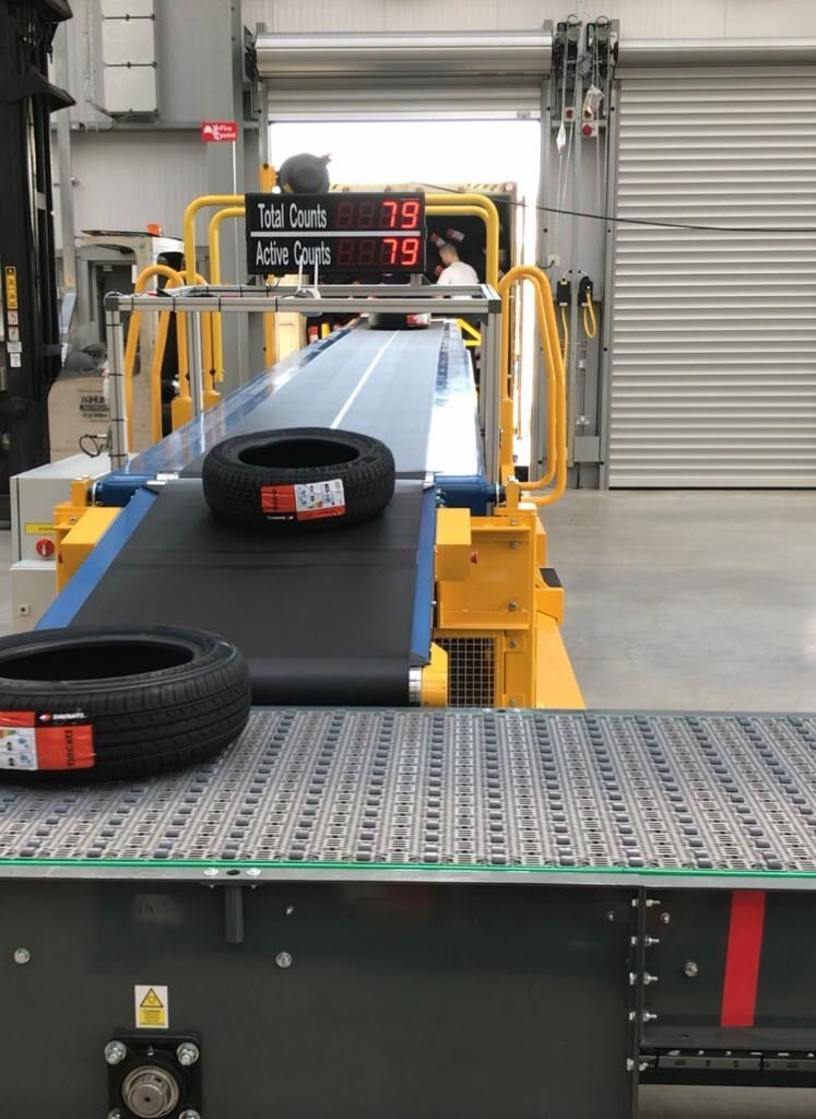 A tire is on a conveyor belt in a factory