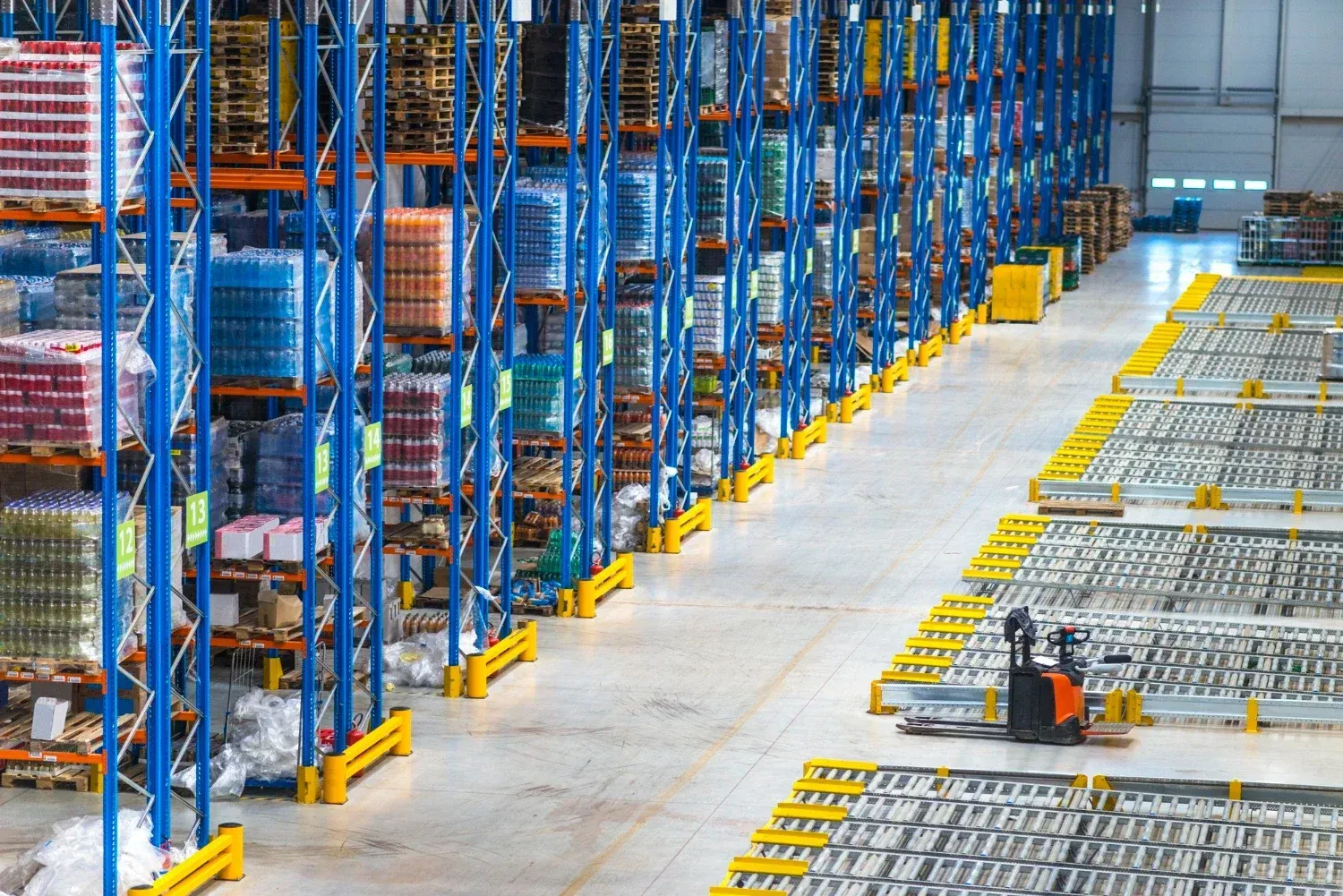 A large warehouse in Florida filled with lots of racks and pallets.