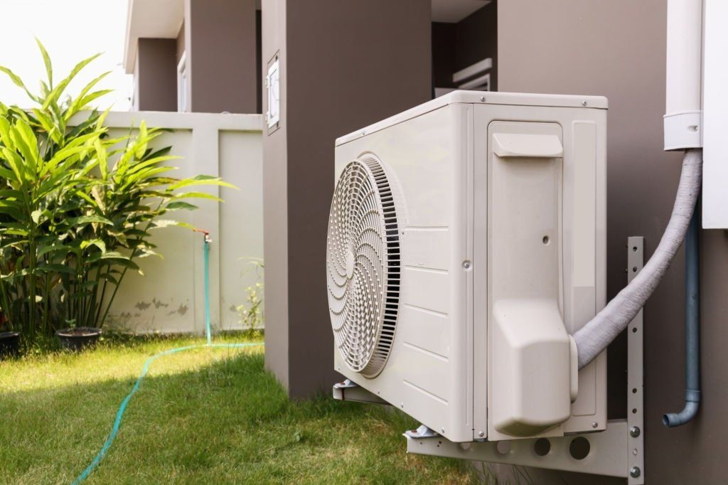 Air conditioning unit mounted on a wall outdoors