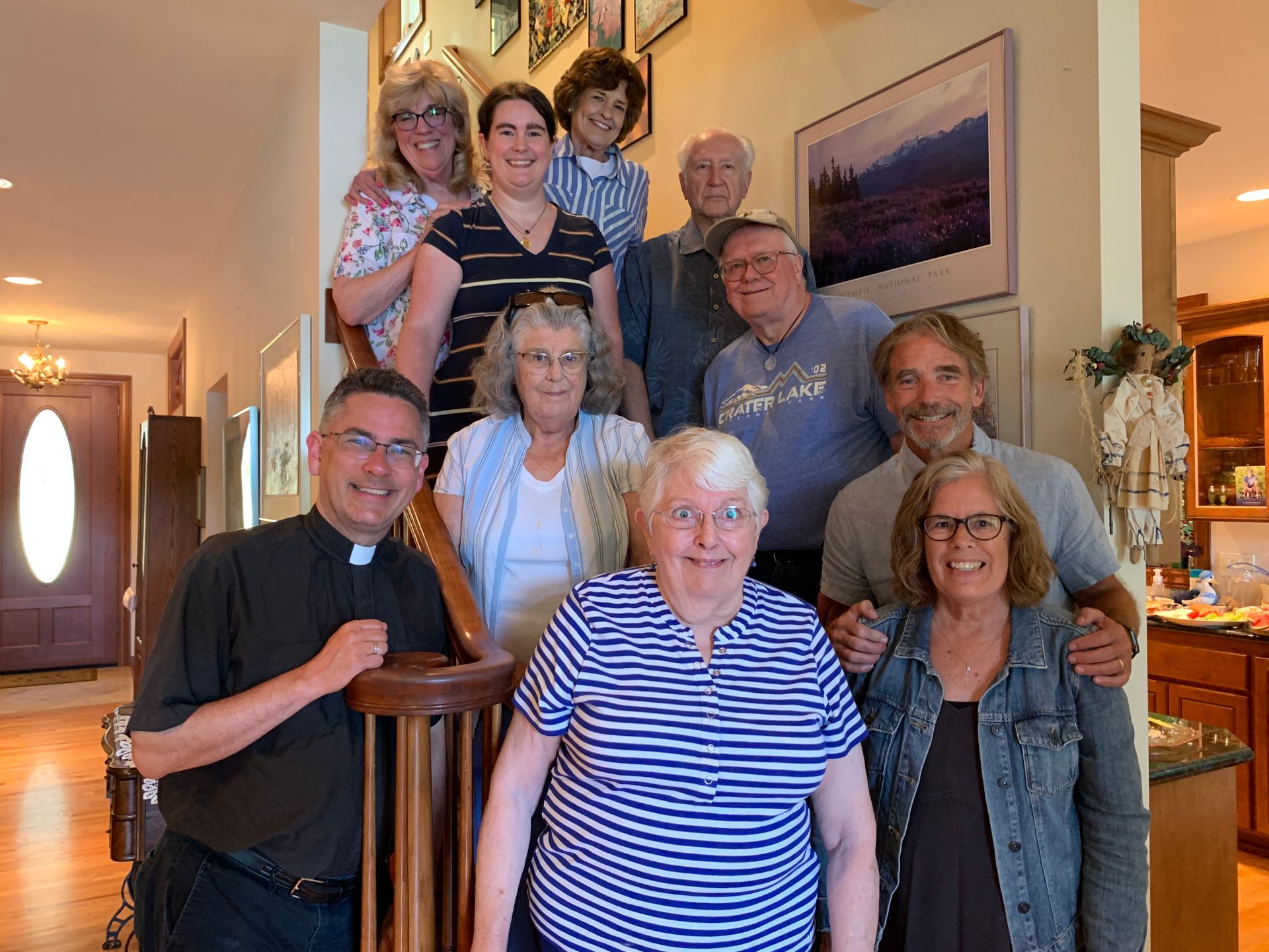 Group of people posing together in a warmly lit living room