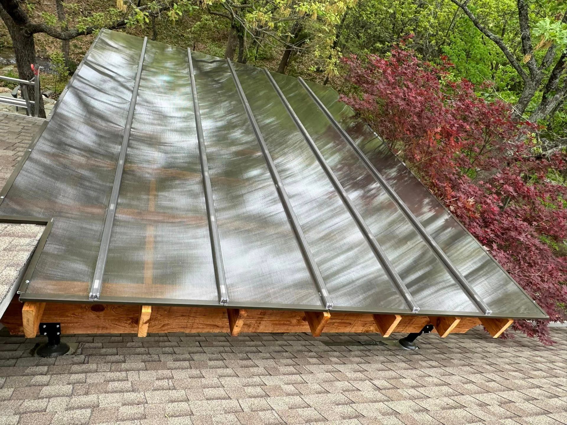 A stainless steel roof is sitting on top of a brick roof.