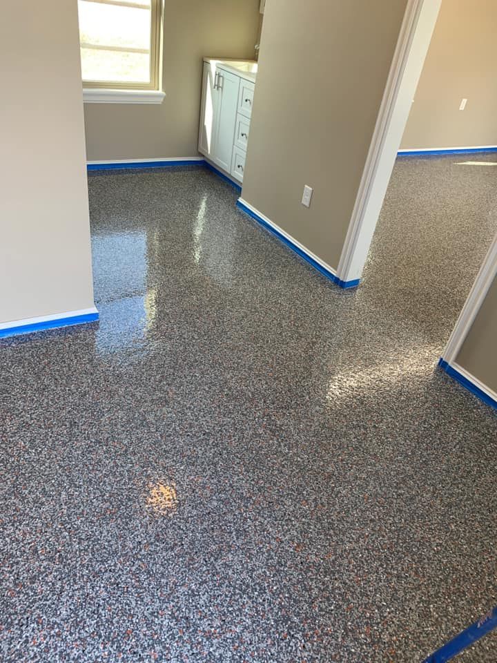 A laundry room with a shiny floor and a washer and dryer.