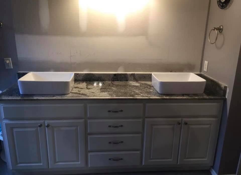 There are two sinks on the counter in the bathroom.