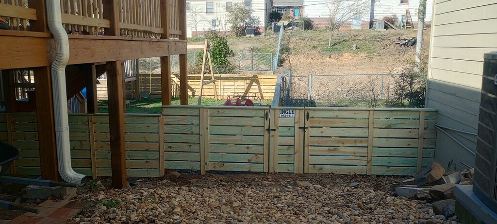 there is a wooden fence in the backyard of a house