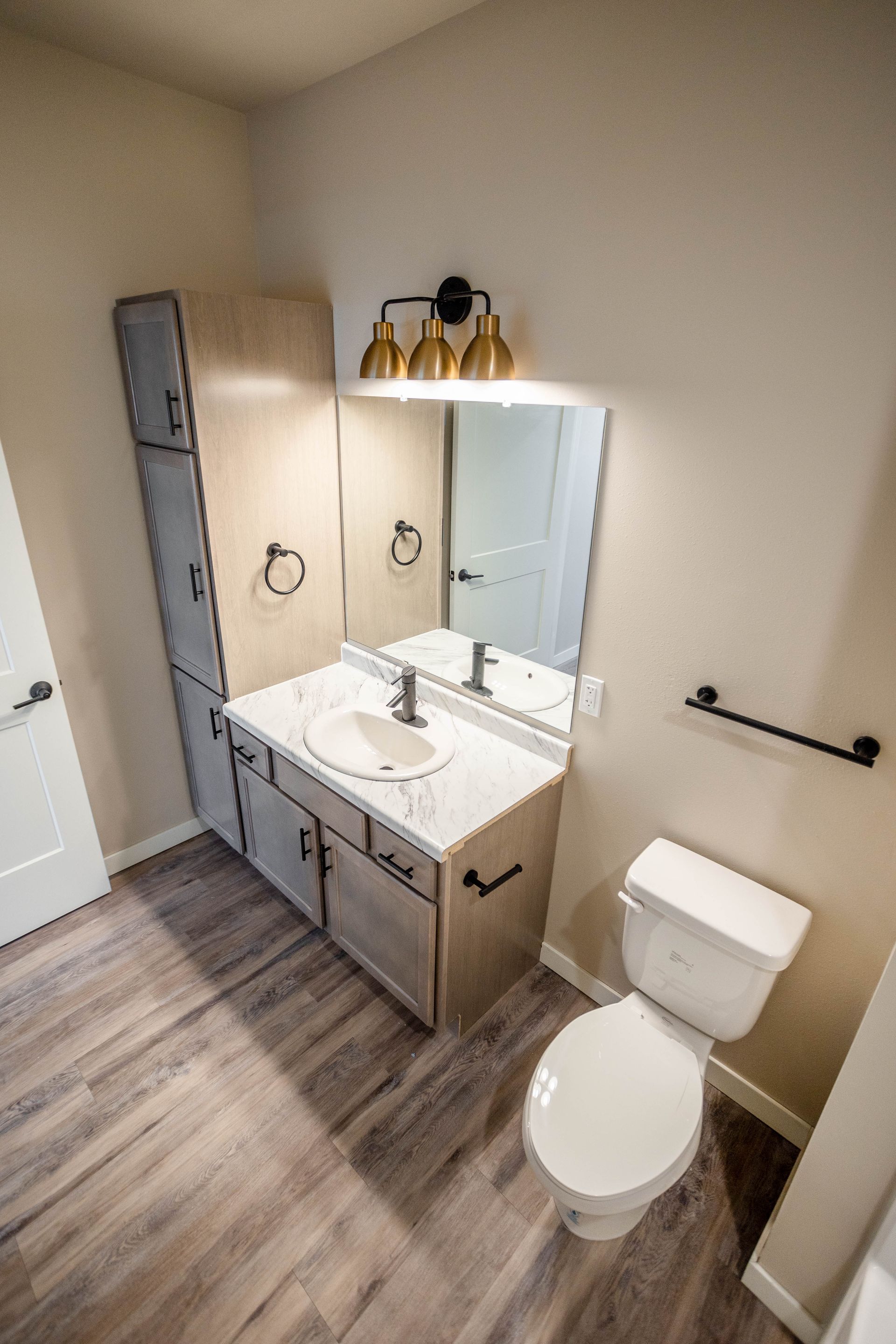 A bathroom with a sink , toilet and mirror.