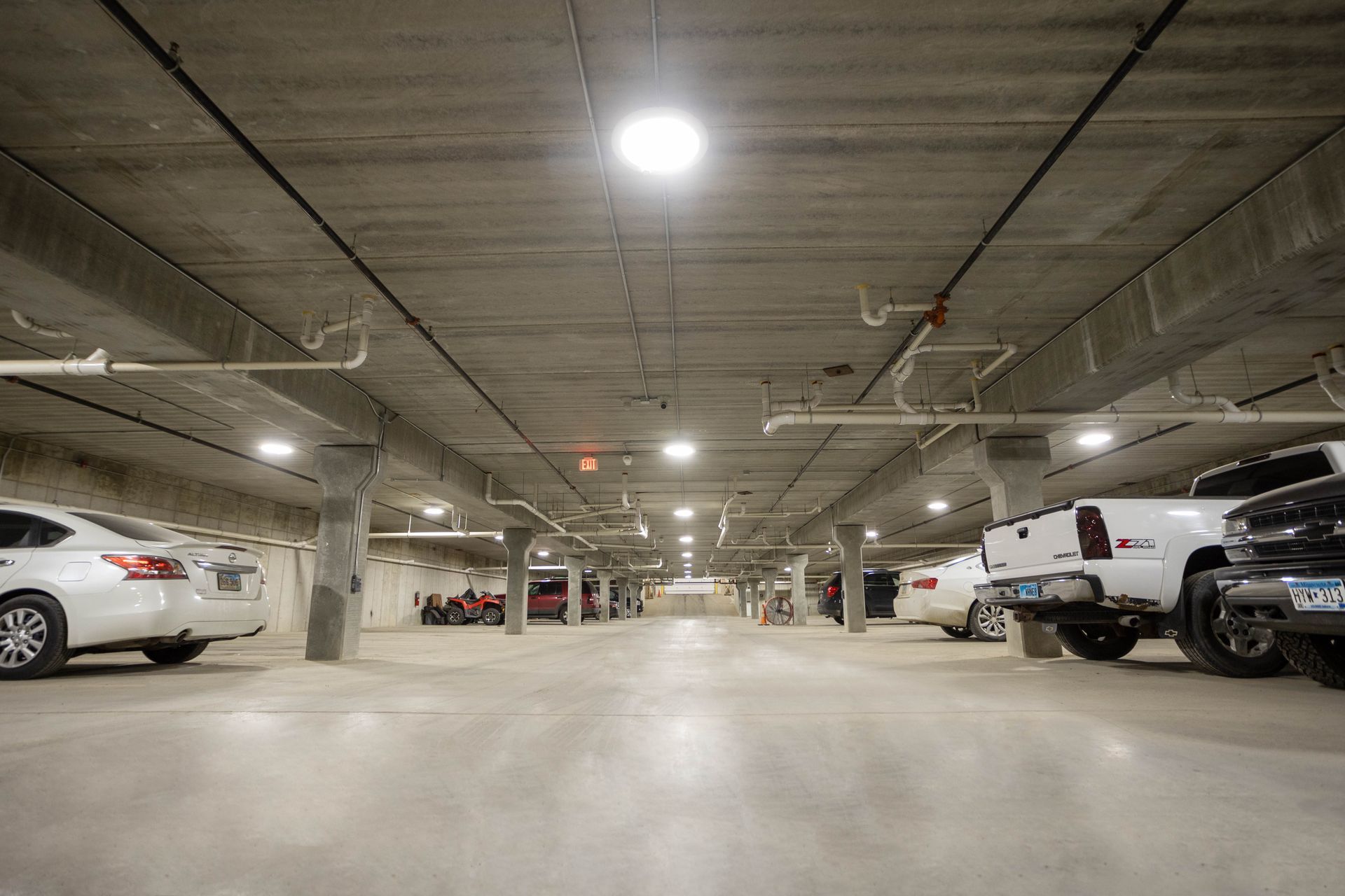 A lot of cars are parked in a parking garage.