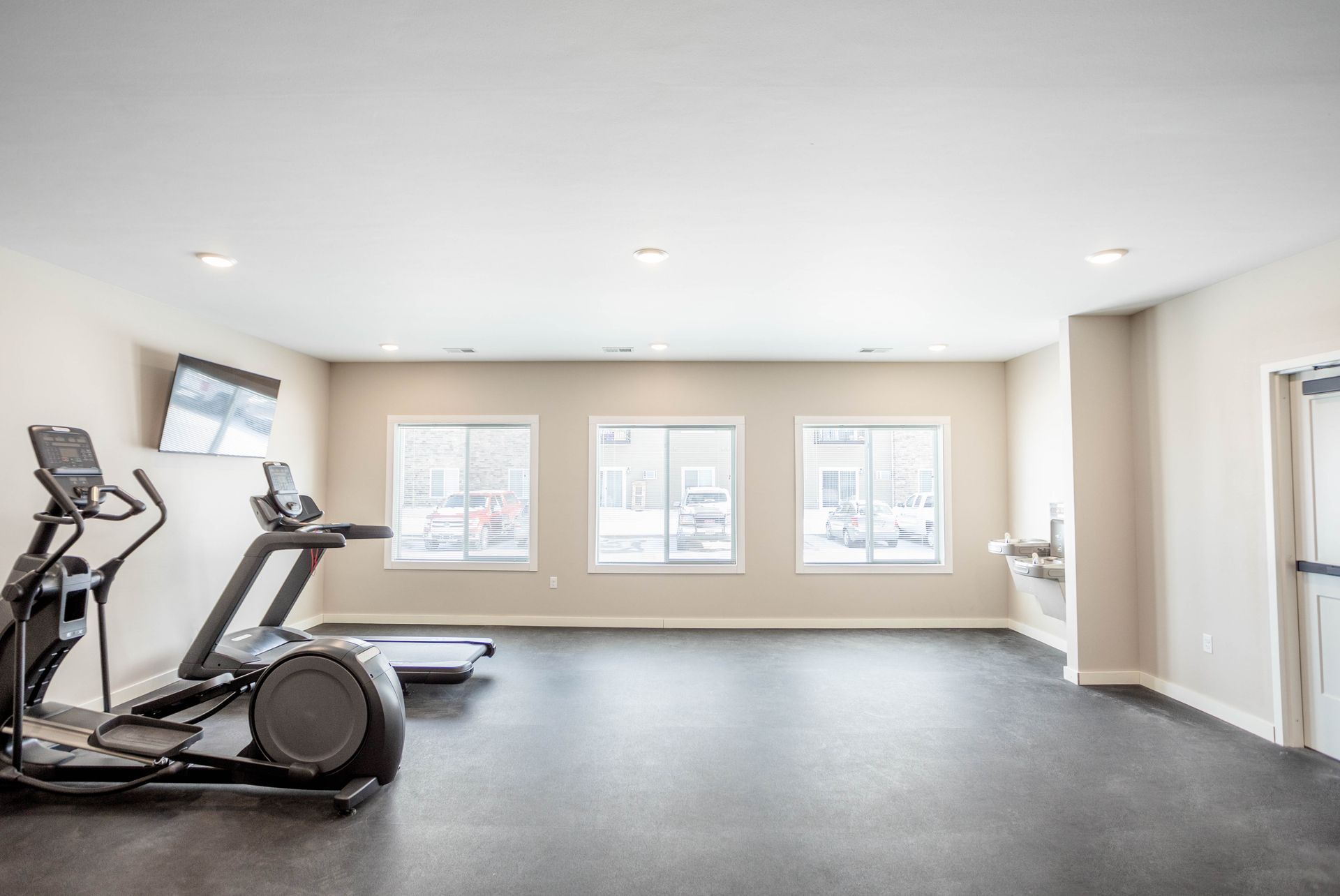 There are two treadmills and an elliptical in the gym.