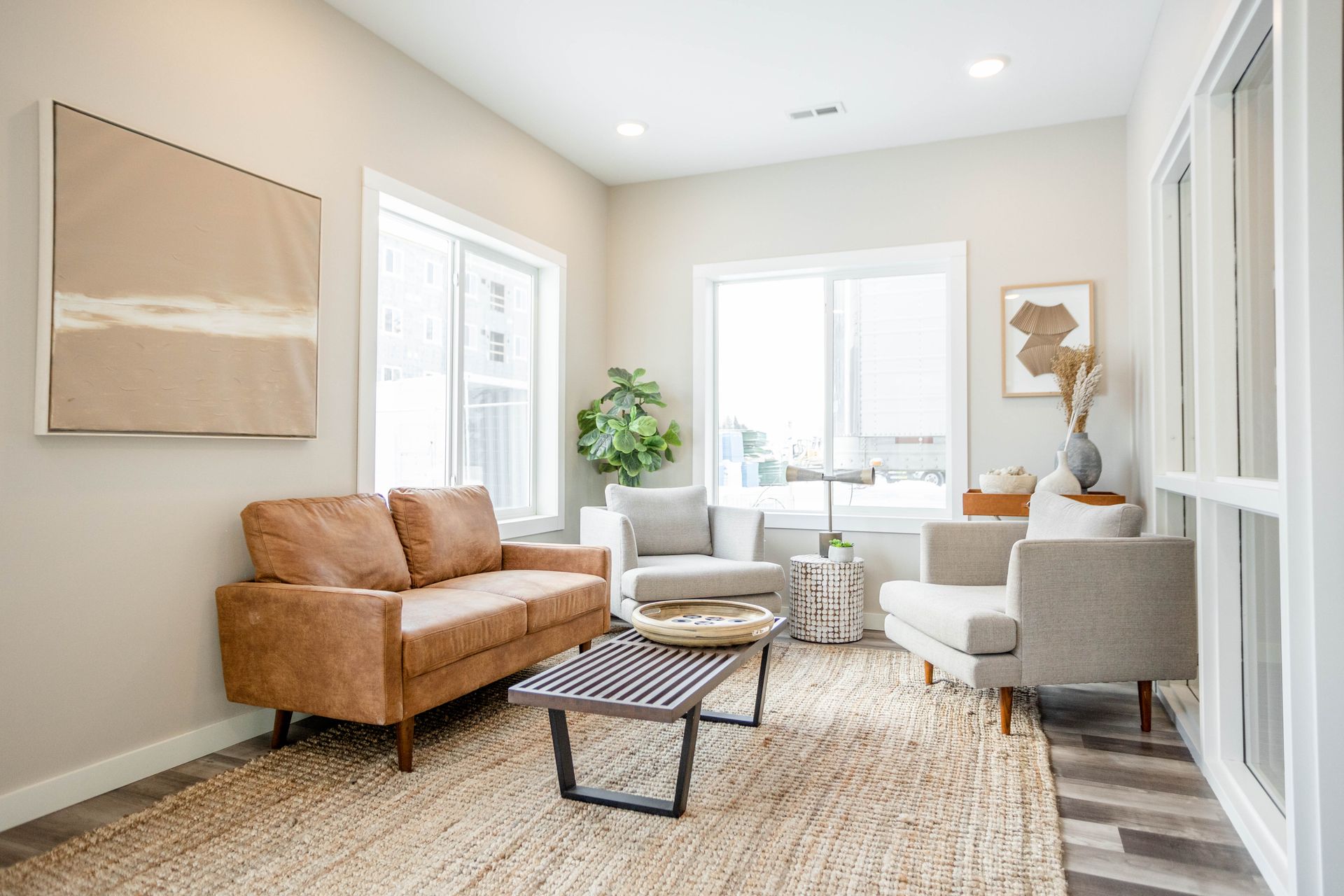 A living room with a couch , chairs , and a coffee table.