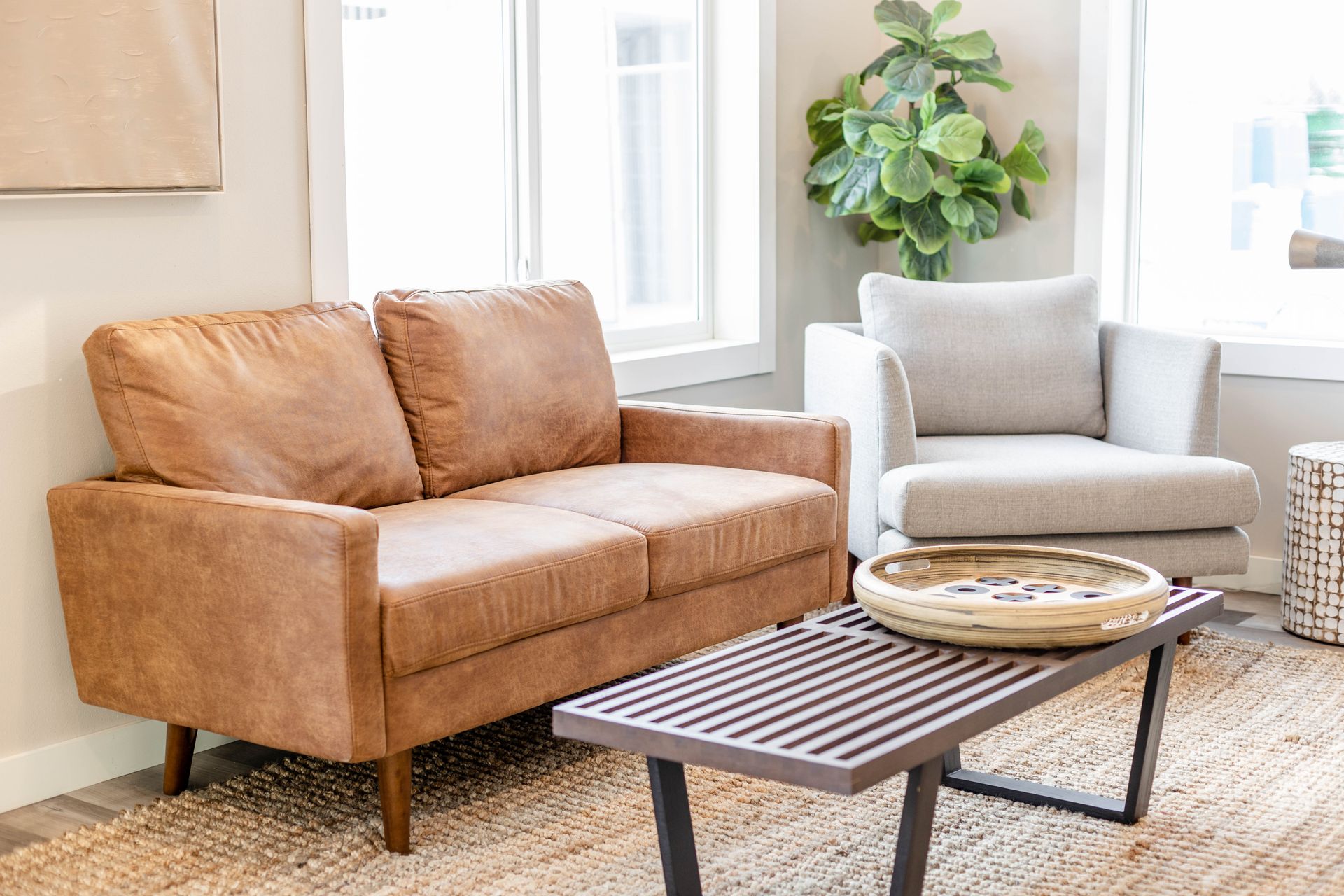 A living room with a couch , chair and coffee table.