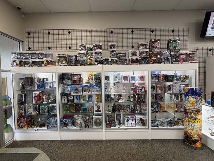 A retail display case filled with collectible figurines and merchandise, in a store setting.