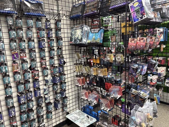 Shelves in a store displaying various trading cards and collectibles in a brightly lit setting.