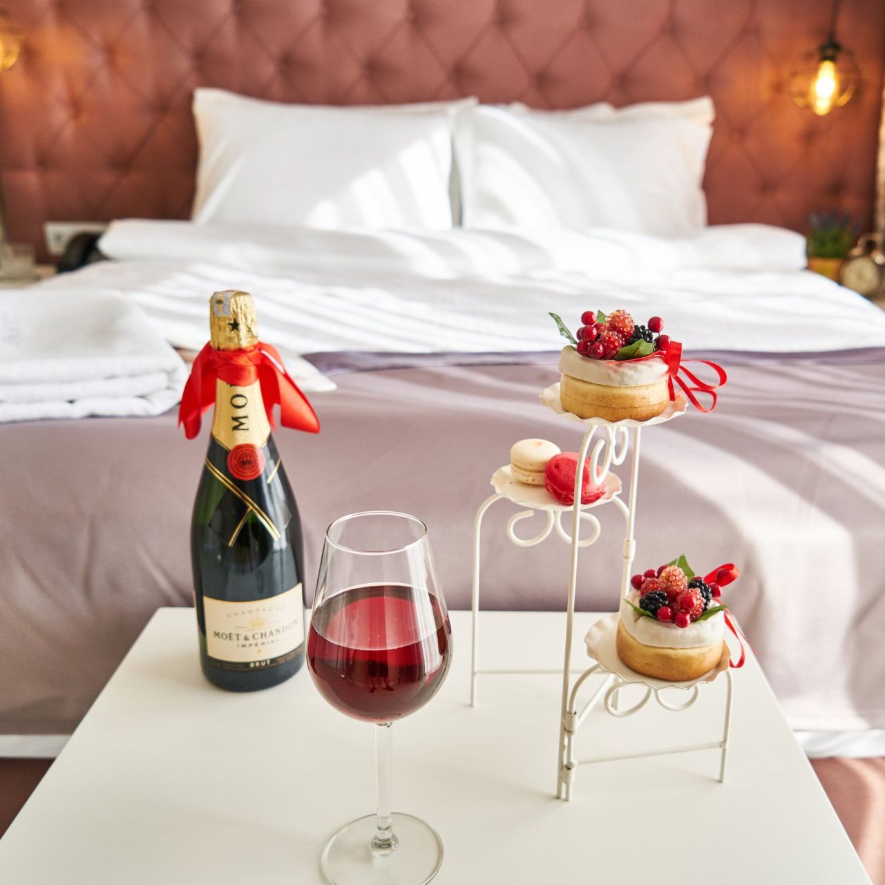 Hotels, Travel Agencies, Hospitality Services A bottle of moet champagne sits on a table next to a glass of wine