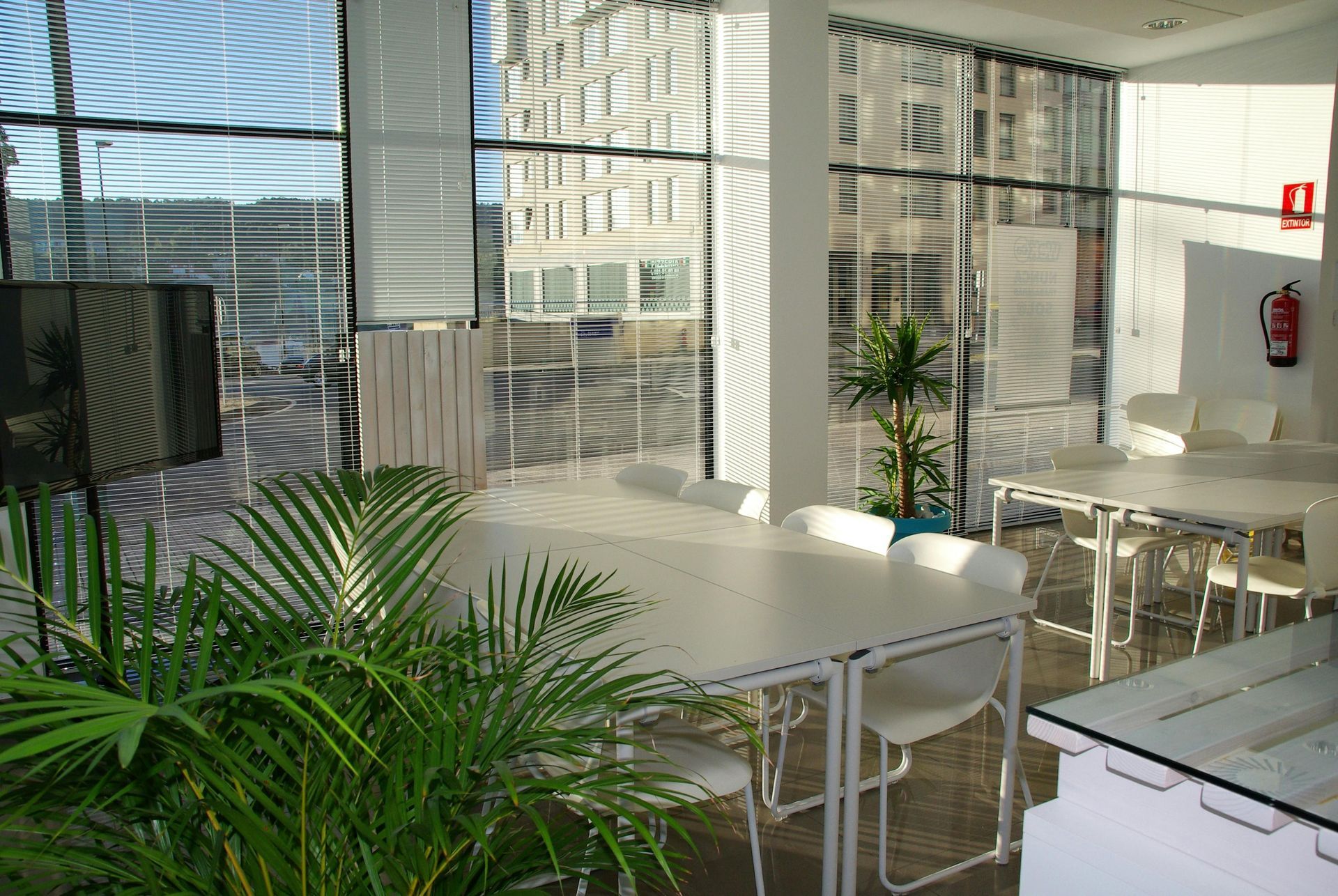 A room with tables and chairs and a fire extinguisher