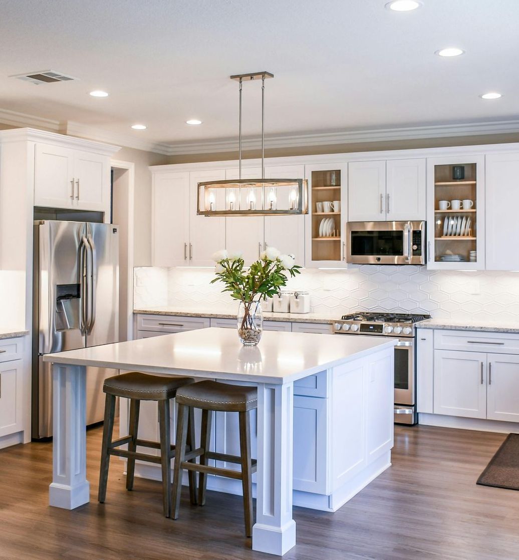 Real Estate and Property Management A dining room with a table and chairs and a chandelier hanging from the ceiling.