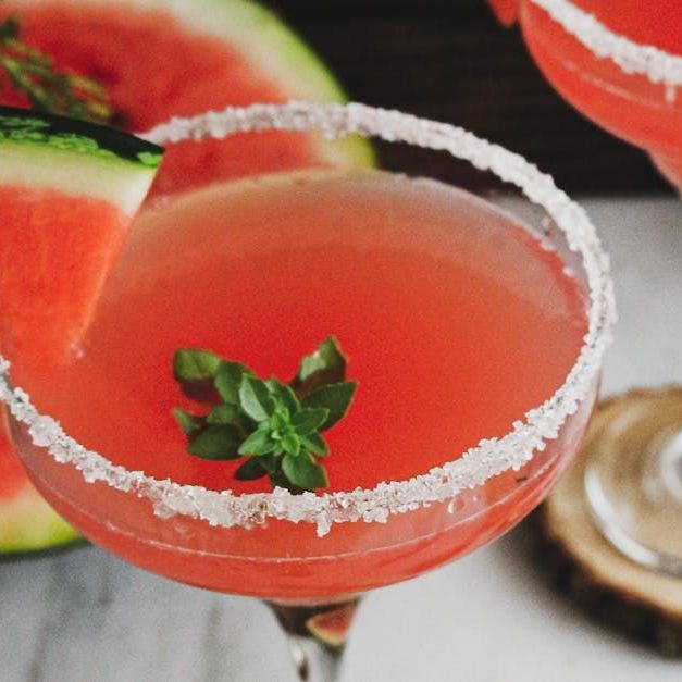 Food Services, Catering, Restaurants and Bars A watermelon martini with a slice of watermelon in it