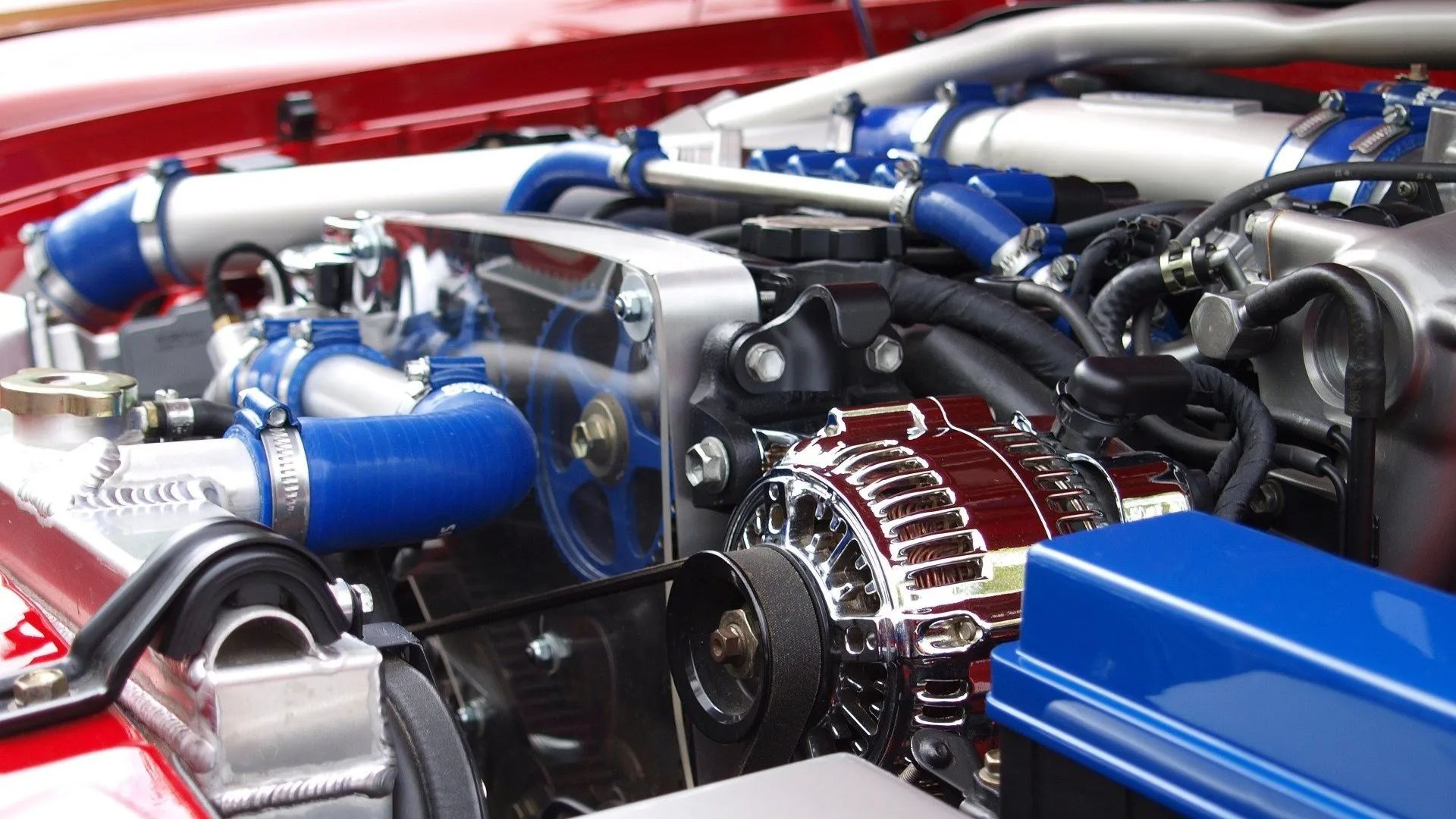 Automotive Services, Auto Repair, Tinting and Detailing A close up of a car engine with blue hoses
